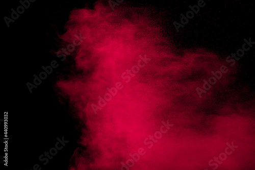 Pink powder explosion.Pink dust splash cloud on dark background.