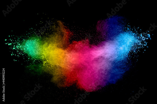 Colorful background of pastel powder explosion.Rainbow color dust splash on black background. © Pattadis