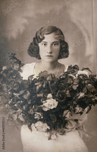 Germany - CIRCA 1930s: Wedding portrait of female with flowers in studio, Vintage Carte de Viste Art Deco era photo photo