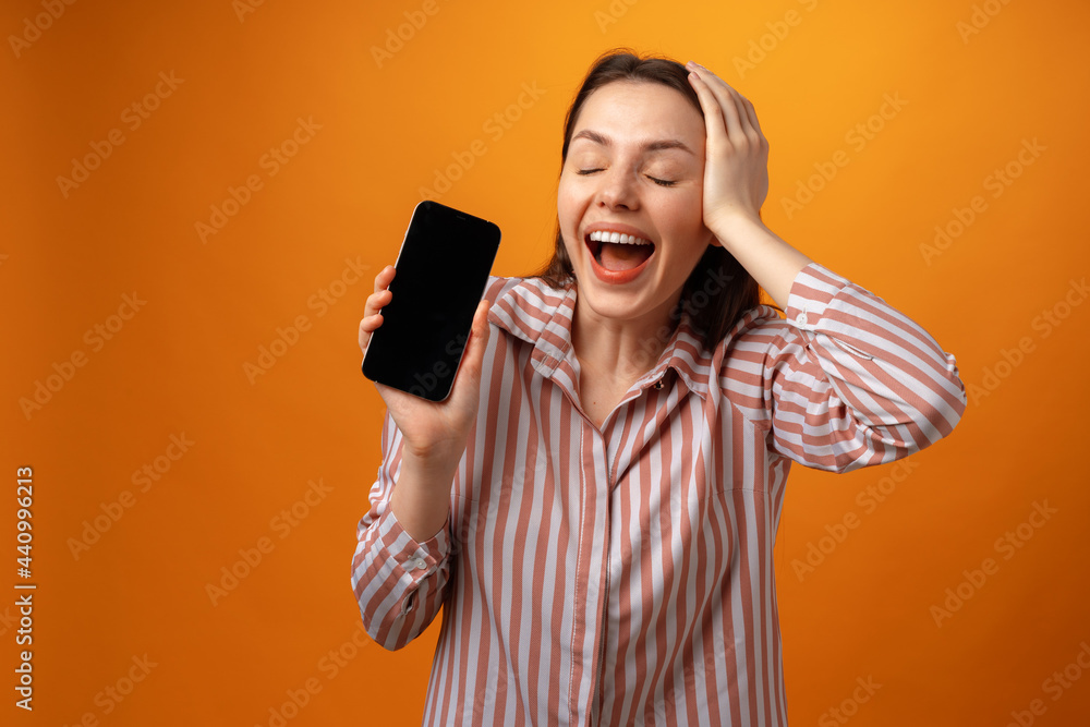 Happy smiling young woman showing you black smartphone screen with copy space Happy smiling young woman showing you black smartphone screen with copy space