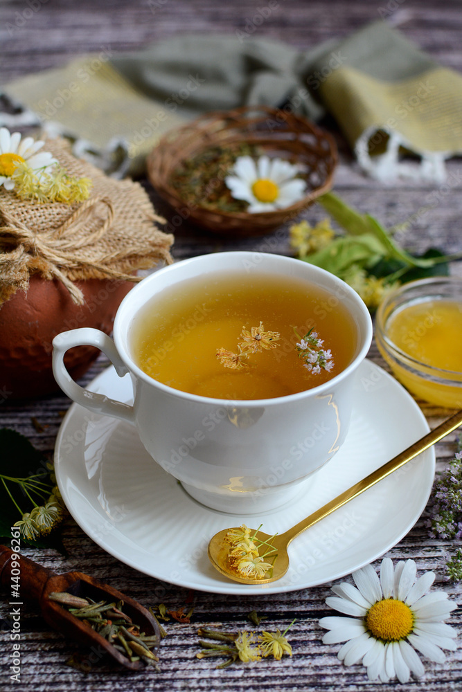Close-up white cup with chamomile tea and honey on a wooden background. Vertical Close-up white cup with chamomile tea and honey on a wooden background. Vertical