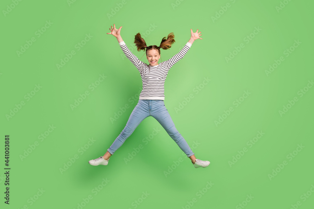 Photo of sweet adorable school girl wear white pullover smiling jumping high like star isolated green color background