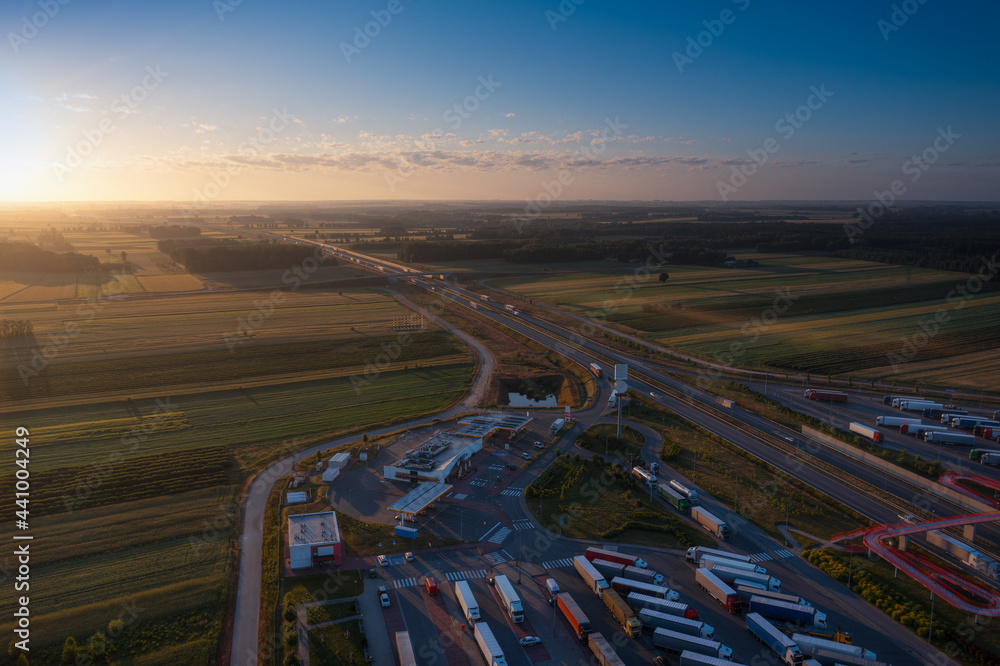 Sun just rises over the highway. Aerial view from the rest area.