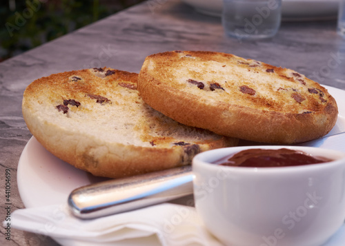 Close up low angle view of toasted teacakes which is a traditional British bun containing raisins sultanas and spices