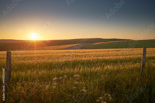 Rural landscape with the sun setting over the hills.