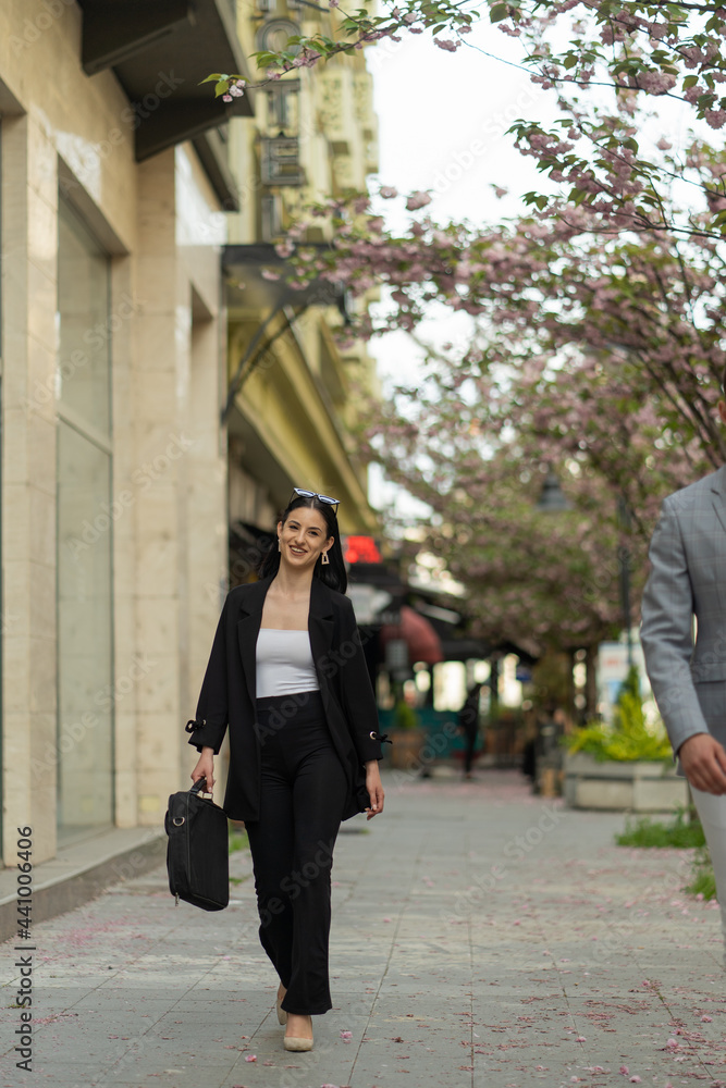 Businesswoman is smiling while walking Businesswoman is smiling while walking