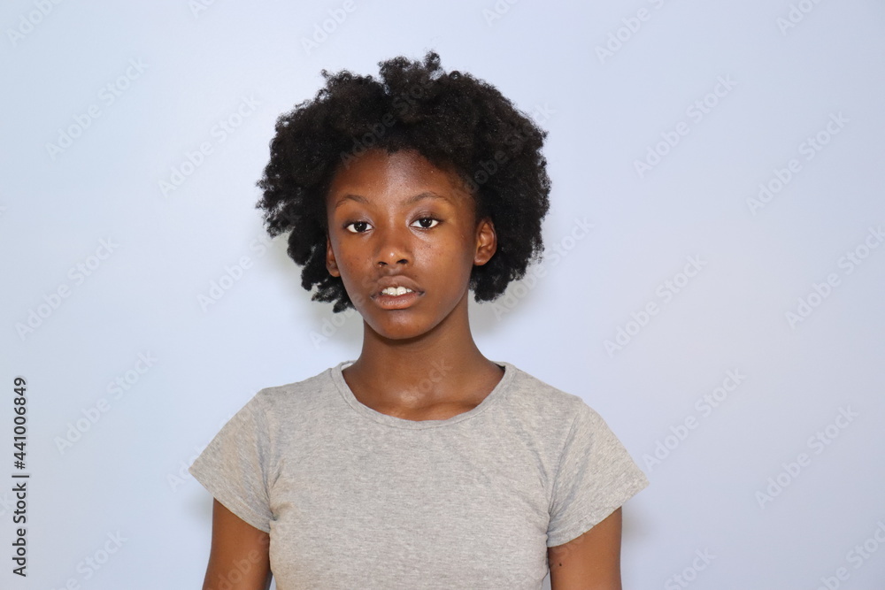 Black Teenage girl close up with acne indoors white background