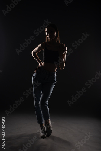 Silhouette of beautiful girl posing isolated on black