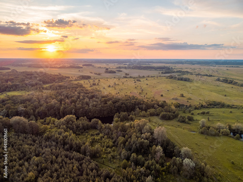 Calm landscape of forests and fields during the sunset. Rural landscape made with a drone