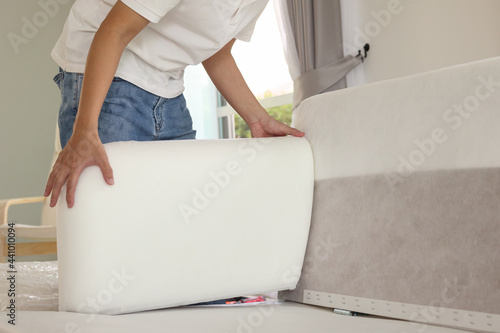 Man assembling sofa furniture at home