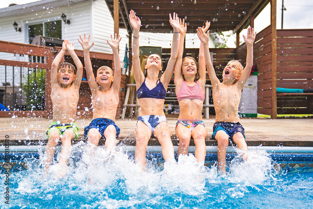 group of children having fun in Pool on the summer time