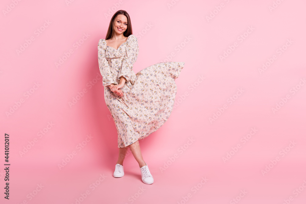 Full length body size photo pretty girl in floral dress smiling isolated pastel pink color background blank space