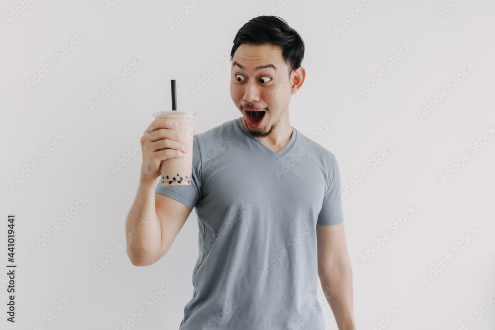 Asian man is feeling happy with his Boba tea isolated on white background. Asian man is feeling happy with his Boba tea isolated on white background.