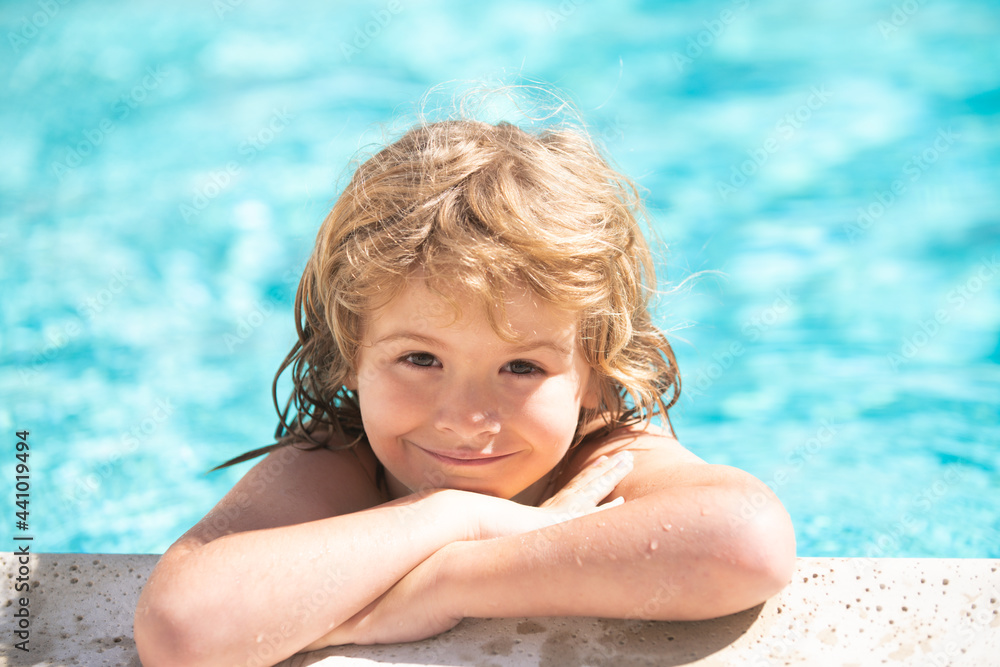 Happy child having fun at swimming pool on sunny day. Boy kid relax in