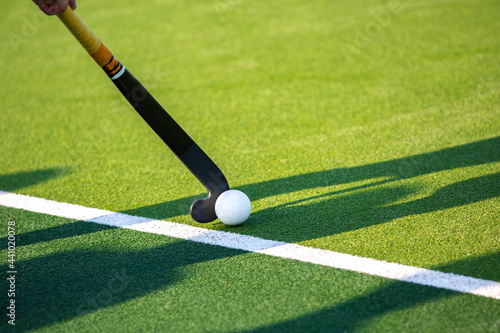 Field hockey player on artificial grass play field. photo