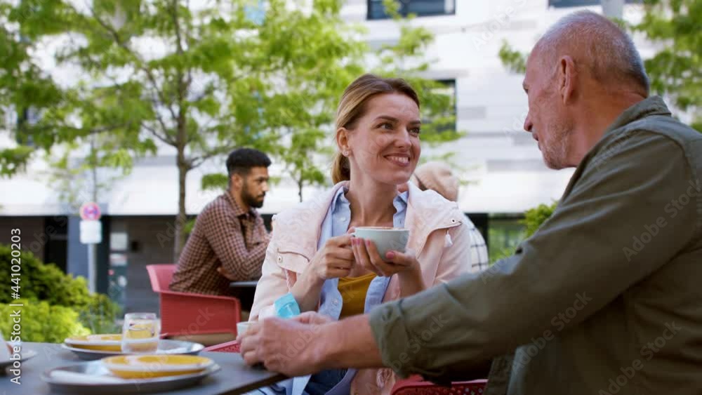 Reunion of friends outdoors in cafeteria, life after covid-19 vaccination and back to normal concept. Reunion of friends outdoors in cafeteria, life after covid-19 vaccination and back to normal concept.