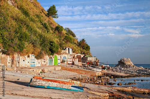 Ancona, Marche, Italy: the metropolitan beach of Passetto with the colorful doors of the caves carved into the rock to shelter the fishing boats photo
