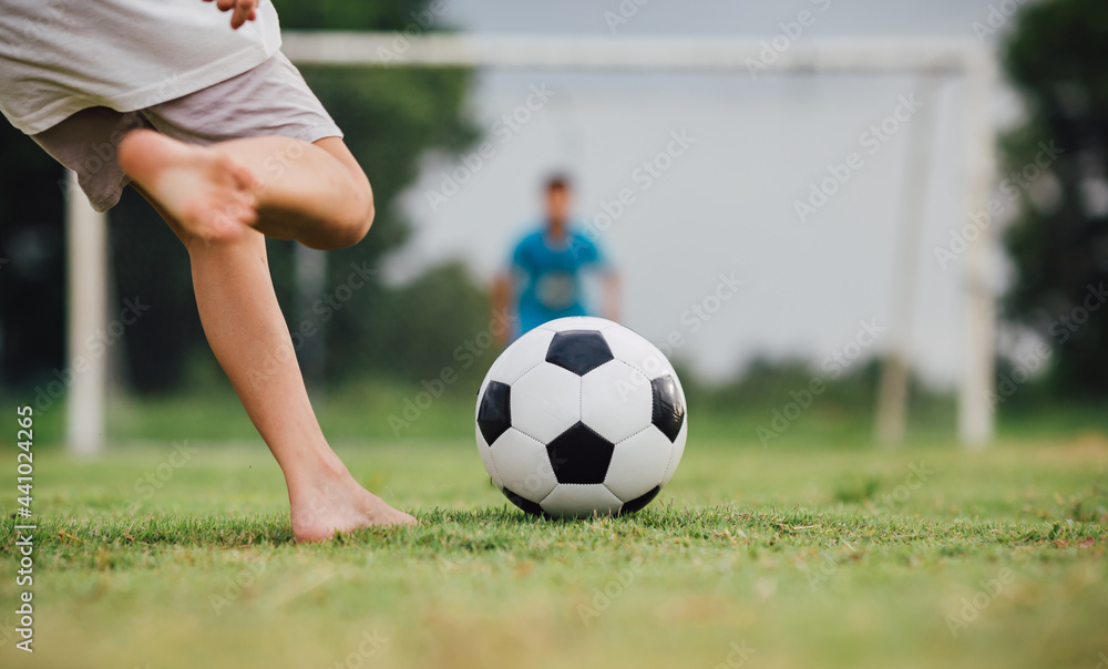 action sport outdoors of diversity of kids having fun playing soccer football for exercise in community rural area under the twilight sunset sky