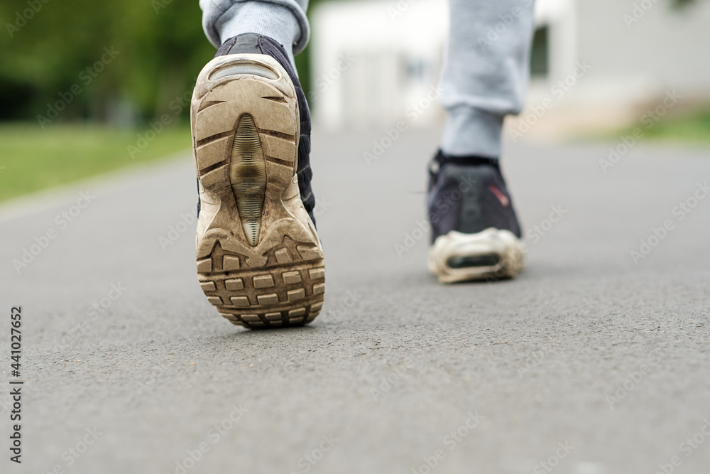 close up of old dirty shoes trainers, walking in a park. close up of old dirty shoes trainers, walking in a park.