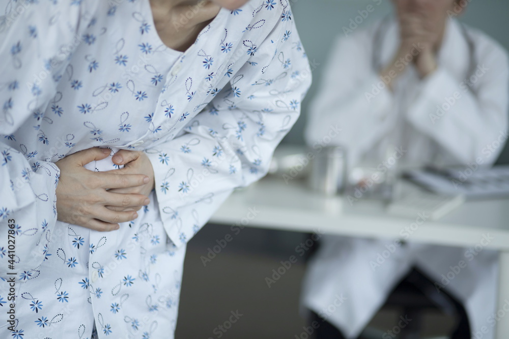 Doctor checking patient's stomach pain Doctor checking patient's stomach pain