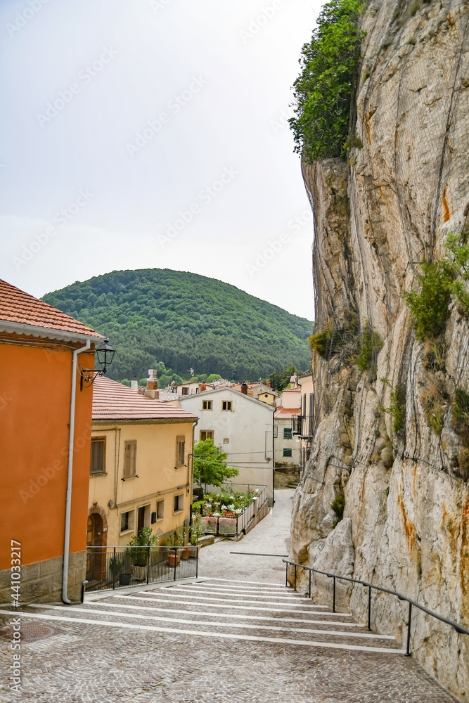 Fototapeta premium A small street between the old houses of Pietrabbondante, a medieval village in the mountains of the Molise region in Italy.