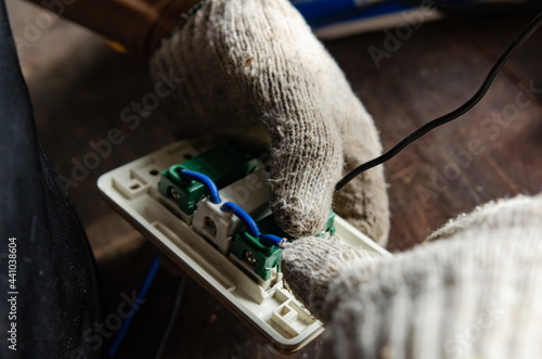 An electrician who is connecting electricity in a residential house.