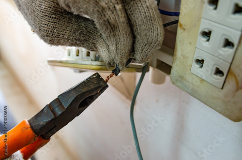 An electrician who is connecting electricity in a residential house.