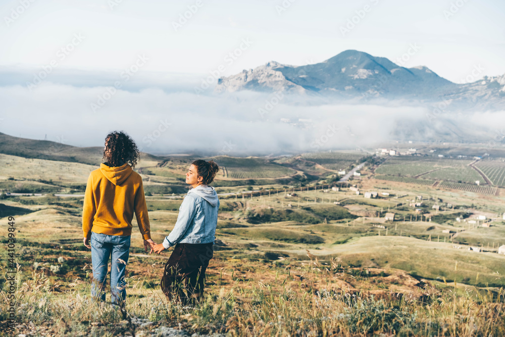 Happy couple standing in mountains.