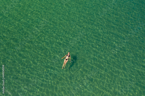 Aerial view of a girl swimming in the Adriatic Sea, Croatia