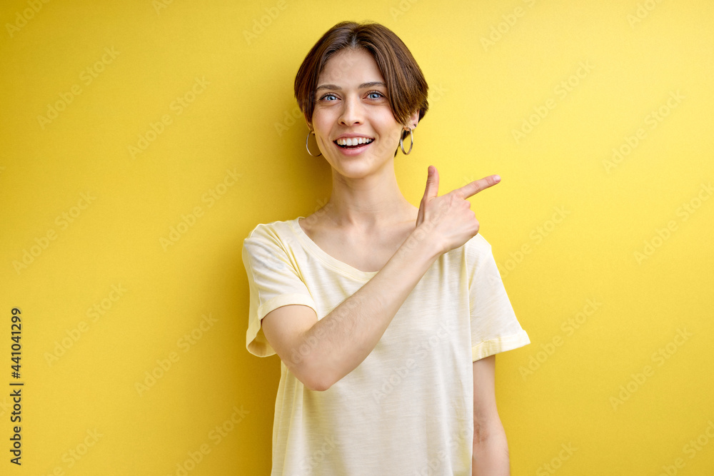 positive adult woman pointing finger at side copy space for advertisement, young female in casual wear advising, showing at something positive adult woman pointing finger at side copy space for advertisement, young female in casual wear advising, showing at something