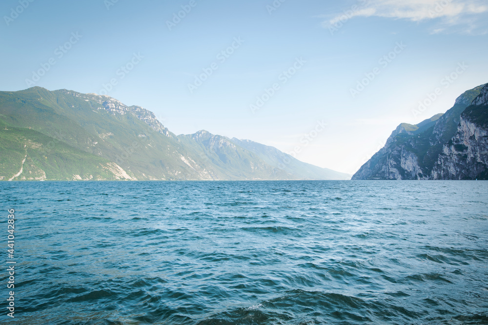 View of the beautiful Lake Garda surrounded by mountains, Scenic view of sunset at Lake Garda in the Riva del Garda with the beautiful sunset colors, italy.
