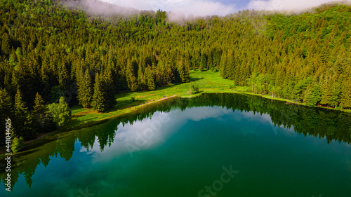 Aerial photography of Saint Ann volcanic lake located In Romania, Harghita county. Photography was taken from a drone at lower altitude from above the lake with camera angle lowerd. photo