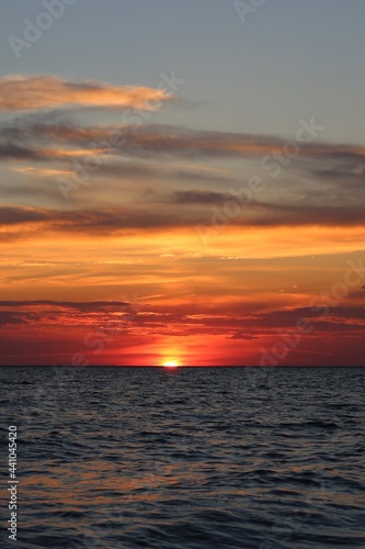 very beautiful red-yellow sunset in the sky and on the seashore