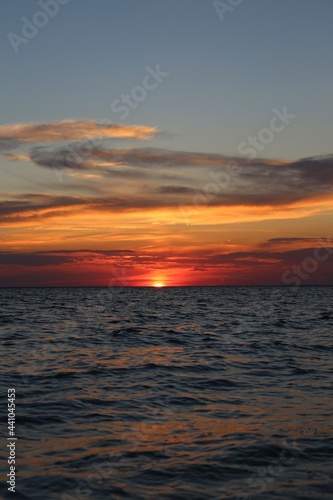 very beautiful red-yellow sunset in the sky and on the seashore