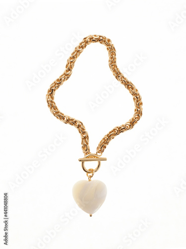 Luxury elegant baroque pearl shaped heart pendant with golden chain isolated on white