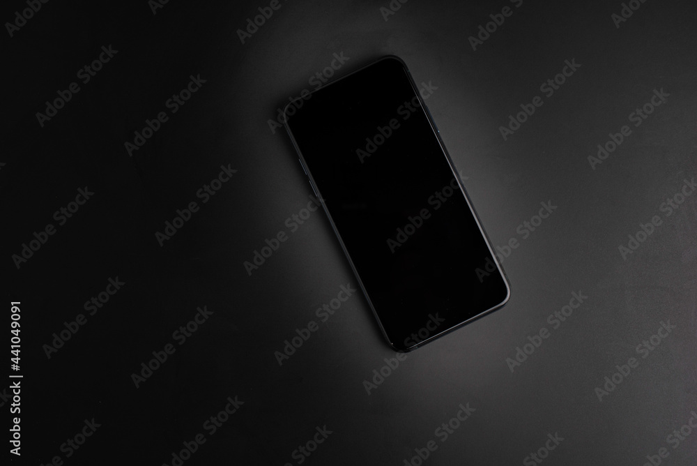 modern smartphone with triple-lens camera against dark background