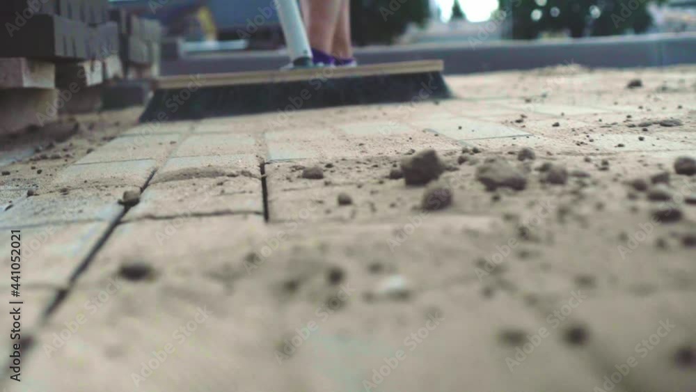 The final stage of laying paving slabs is the filling of gaps with dry