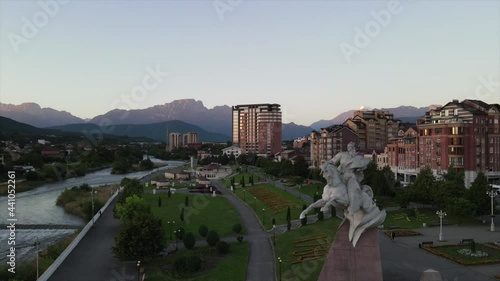 Video from the sunrise drone in the center of Vladikavkaz. On the horizon, you can see the mountains and their snow-capped peaks. The rapid flow of the Terek River. Atmospheric and cozy. photo