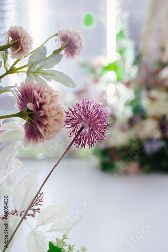 Flower arrangements in transparent small vases on guest tables, decor