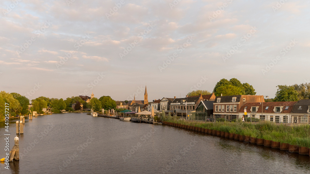 The Amstel river flowing through the town of Ouderkerk aan de Amstel during the evening