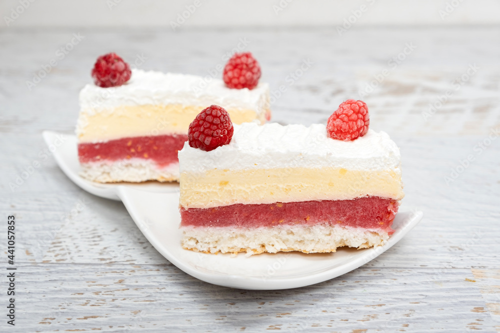 Piece of vanilla slice cake, and raspberries