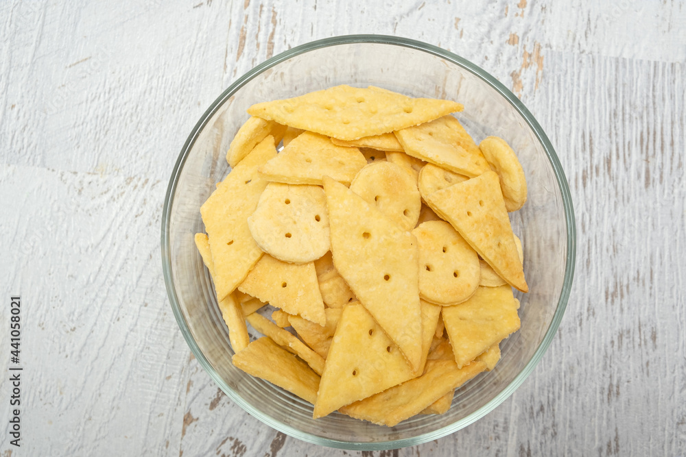 Delicious homemade crackers on white wooden table. Crunchy savory crackers snack idea for kids or adults