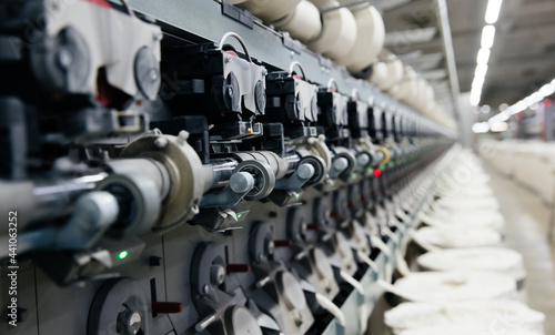 The process of machine operation in a textile factory for the production of cotton thread and yarn