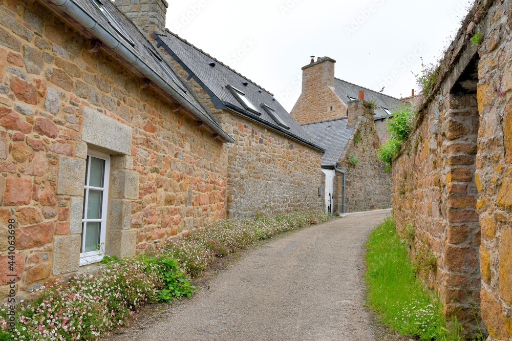 Little street with walls in stones on the Brehat island in Brittany France
