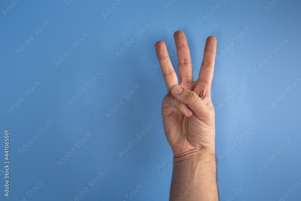 hand on blue screen making number 3 hand on blue screen making number 3