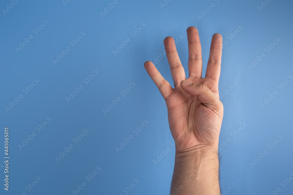 hand on blue screen making number 4