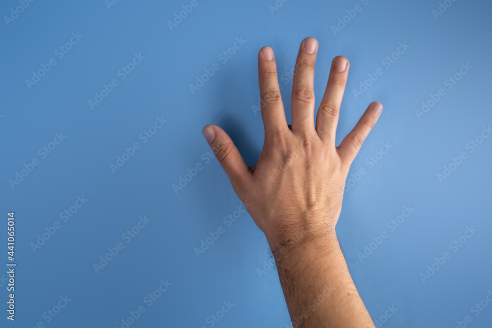 hand on blue screen making number 5 hand on blue screen making number 5