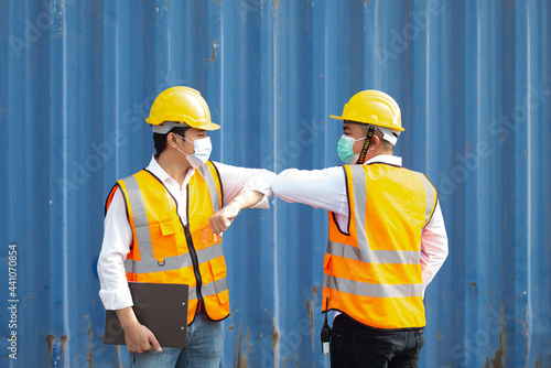 Worker greeting by elbow at commercial dock during pandemic