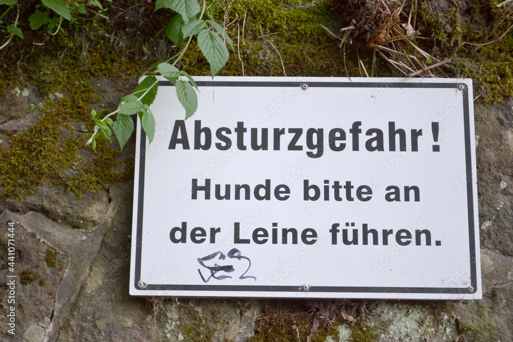 Sign in German: Danger of crash! Please keep your dogs on a leash