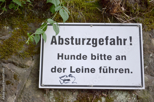 Sign in German: Danger of crash! Please keep your dogs on a leash
